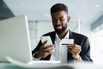 african-american-man-paying-with-credit-card-online-while-making-orders-via-mobile-internet-making-transaction-using-mobile-bank-application (1)