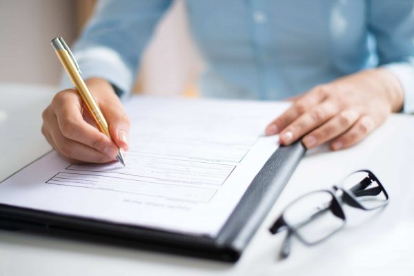 closeup-of-entrepreneur-making-notes-in-document